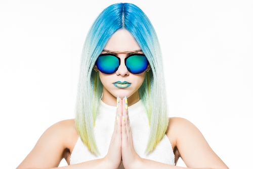 A person with blue hair and sunglassesDescription automatically generated with low confidence